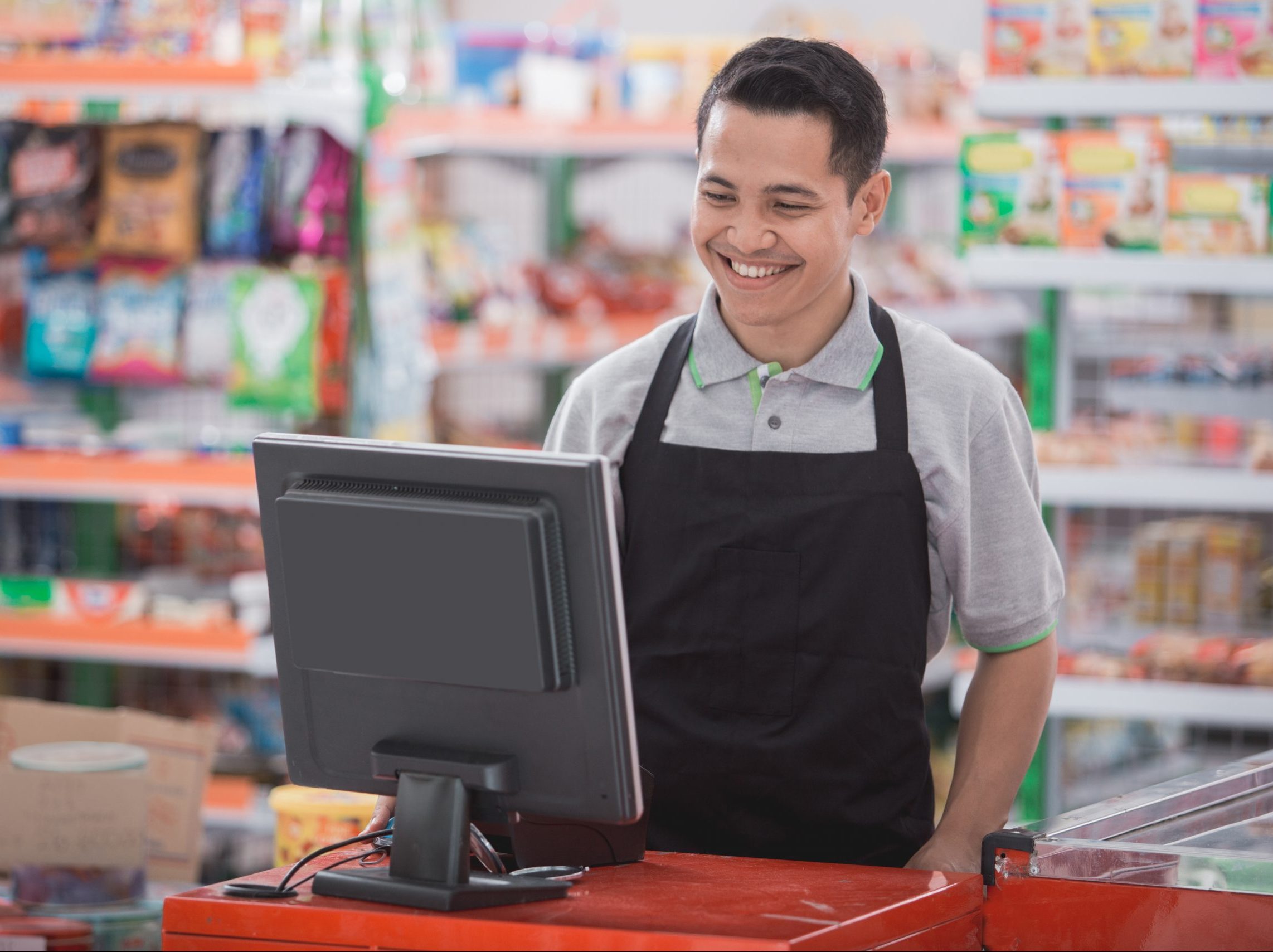 portrait of happy asian male shopkeeper